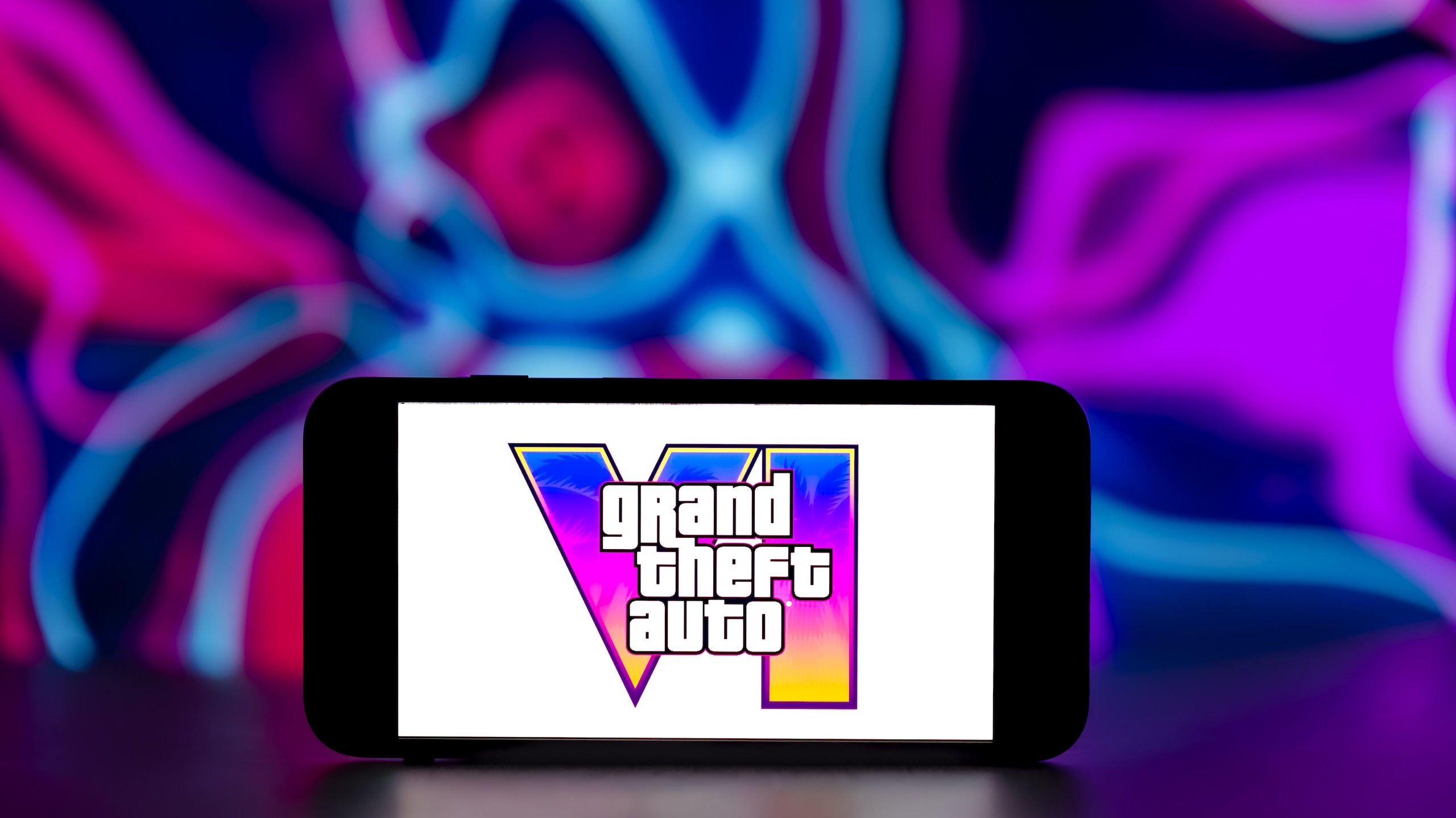 In this photo illustration, the Grand Theft Auto VI logo is...