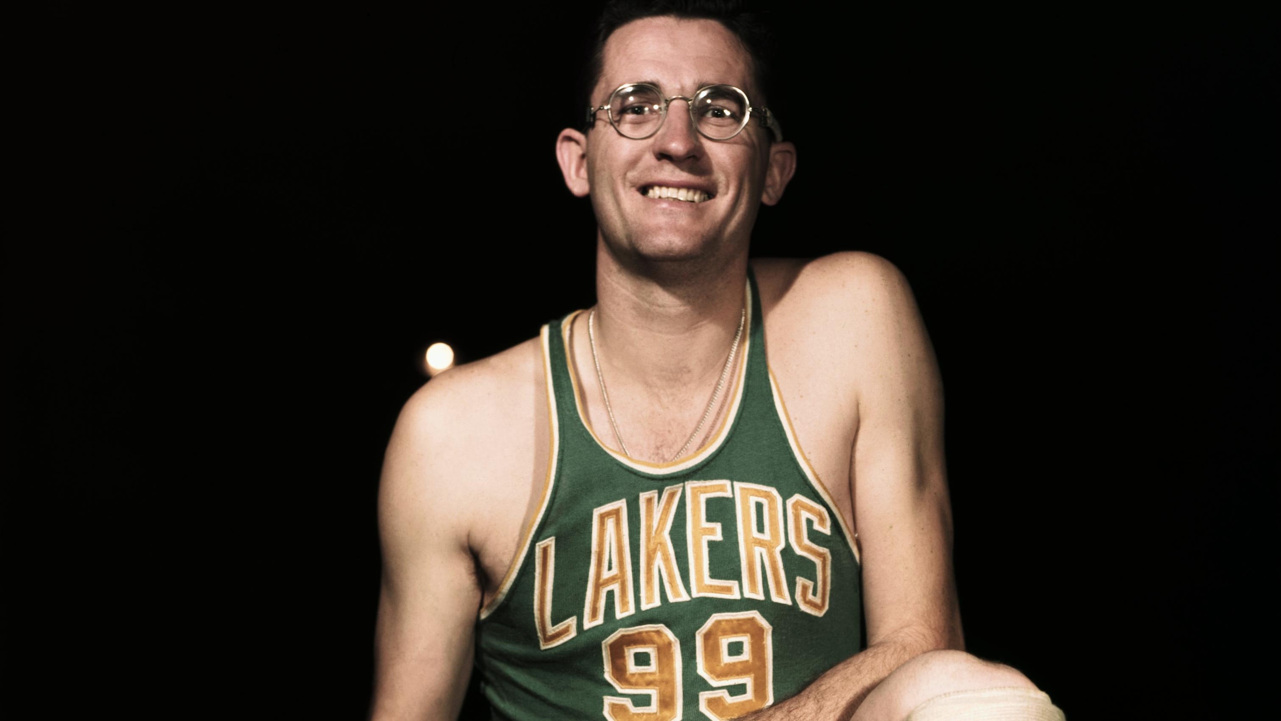 George Mikan Stooping with Basketball