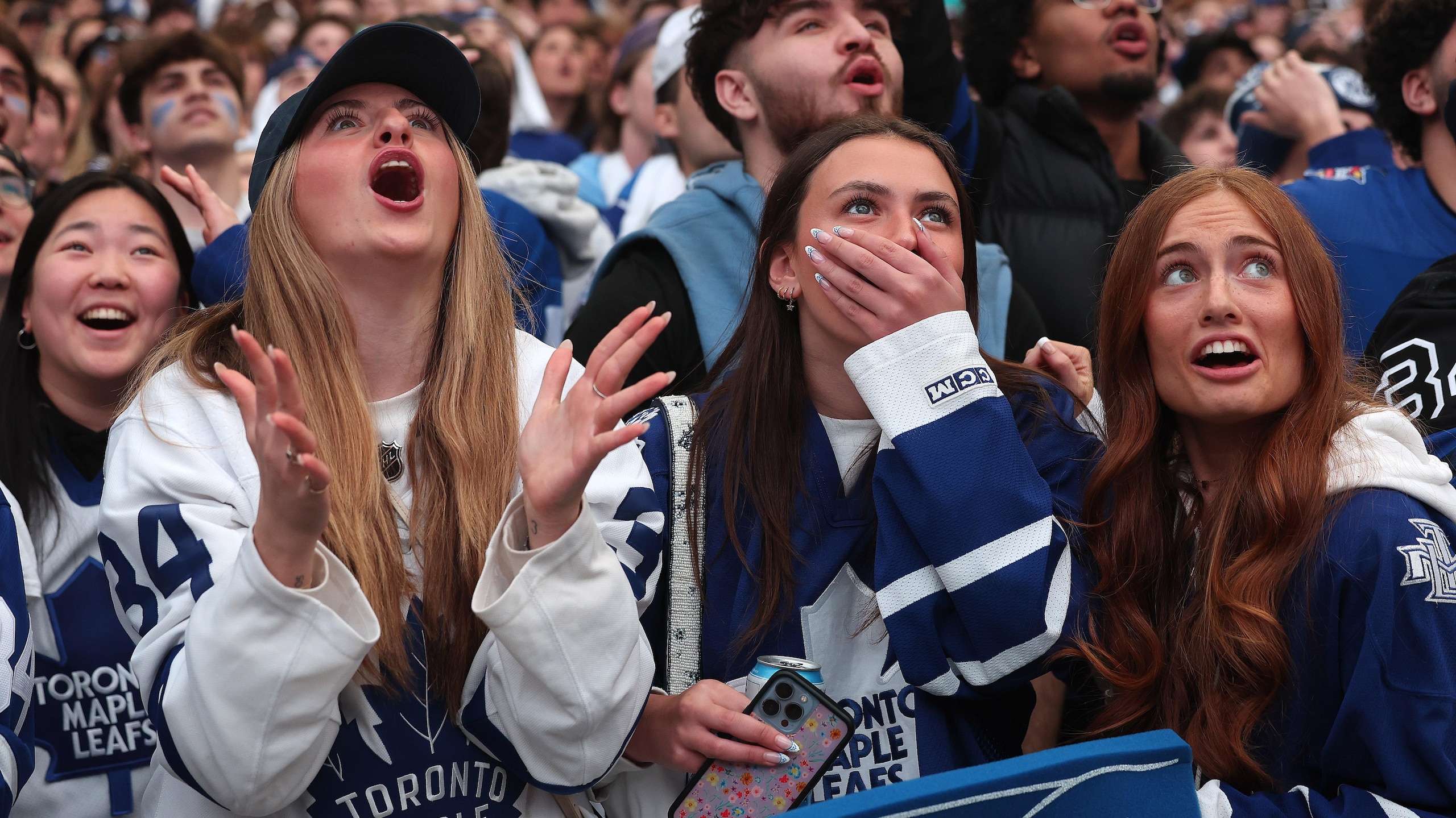 Fans react to a play as they gather in Maple Leaf Square Toronto Maple Leafs play the Boston Bruins in game 5 of their Stanley Cup first round series