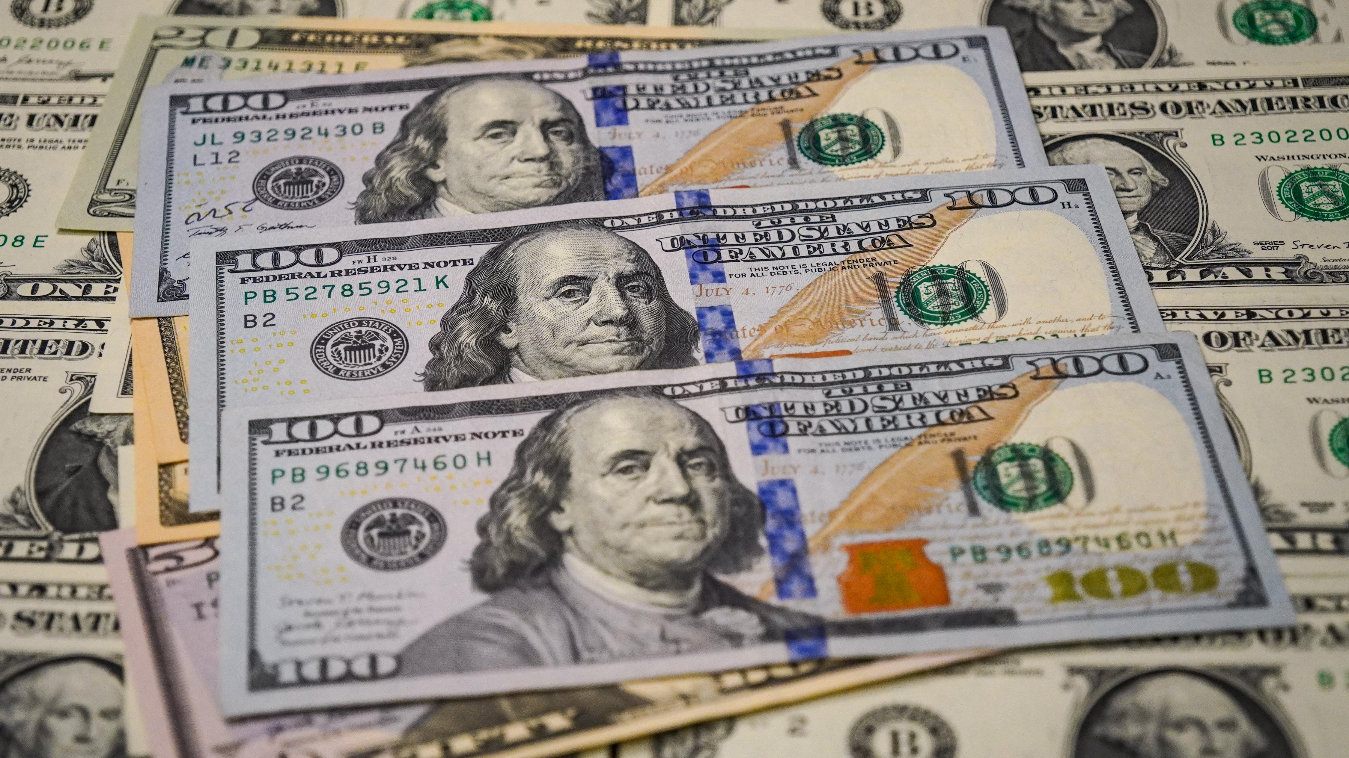 In this photo illustration,  a view of $100 bills seen