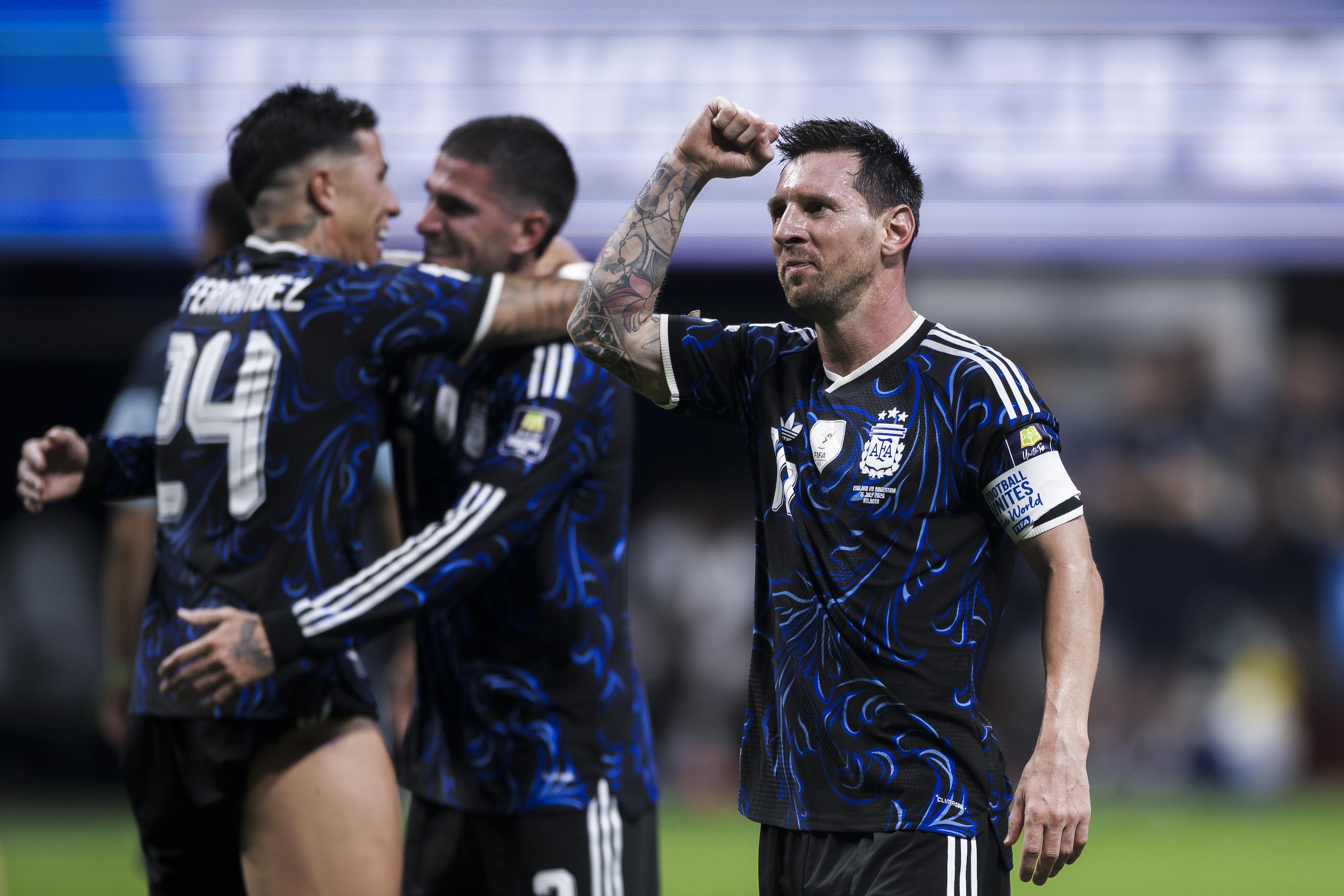 Lionel Messi (R) of Argentina celebrates the victory with Lionel Messi (R) of Argentina celebrates the victory with