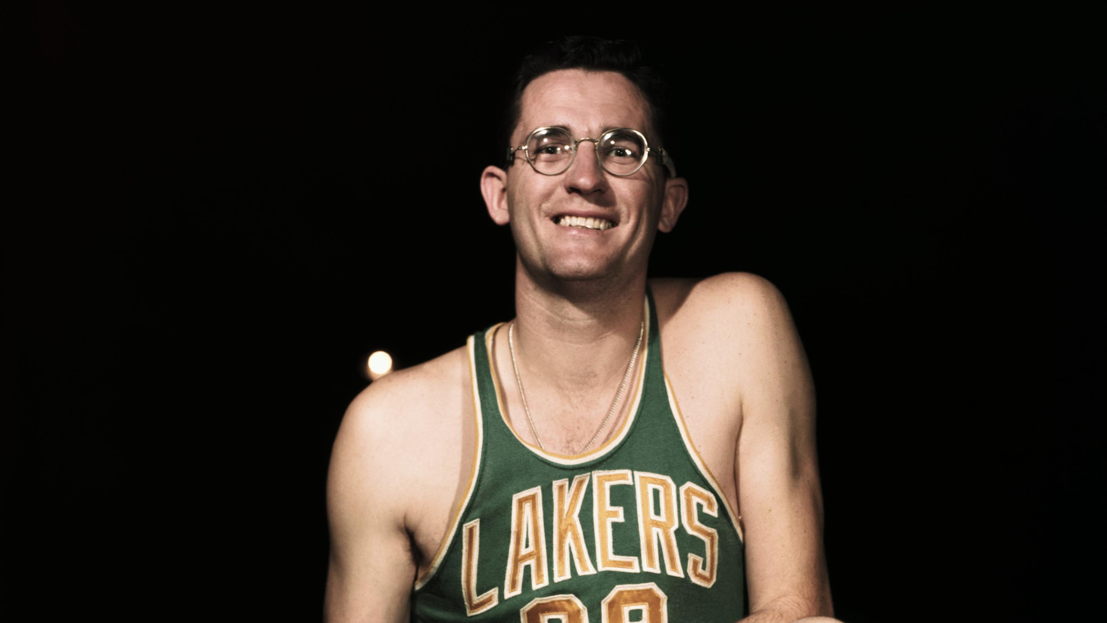 George Mikan Stooping with Basketball