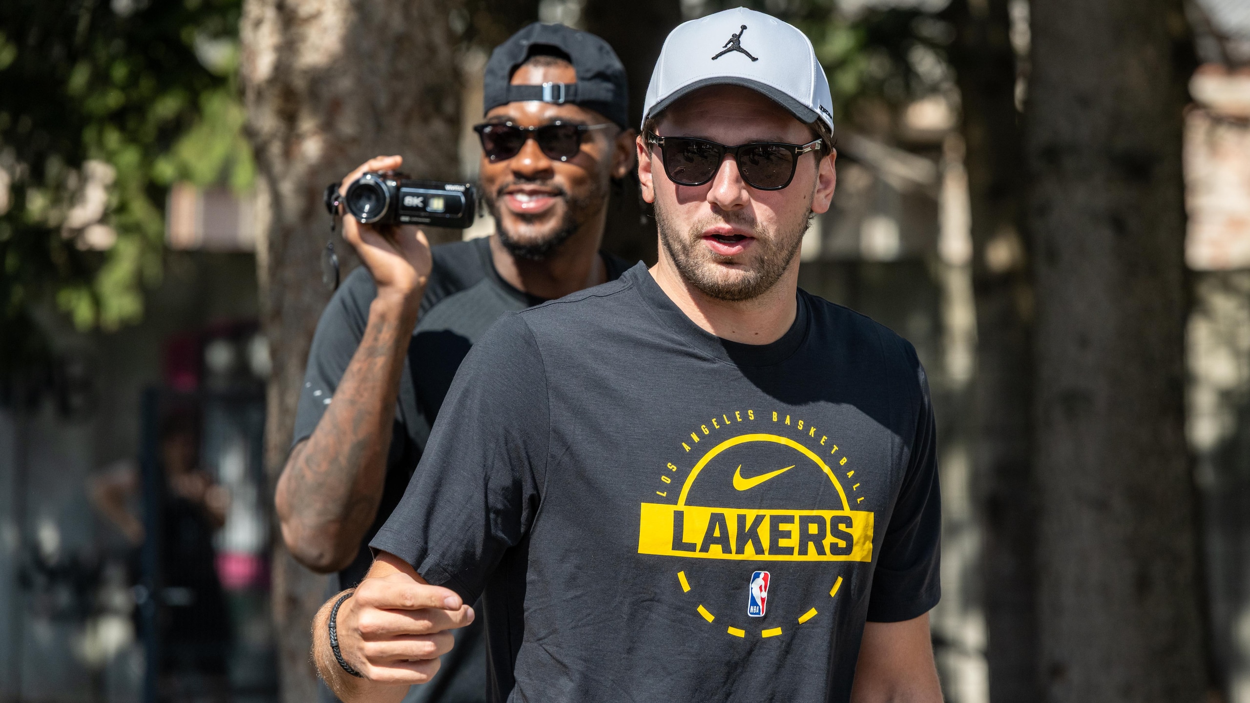 Luka Doncic arrives with members of the Los Angeles Lakers