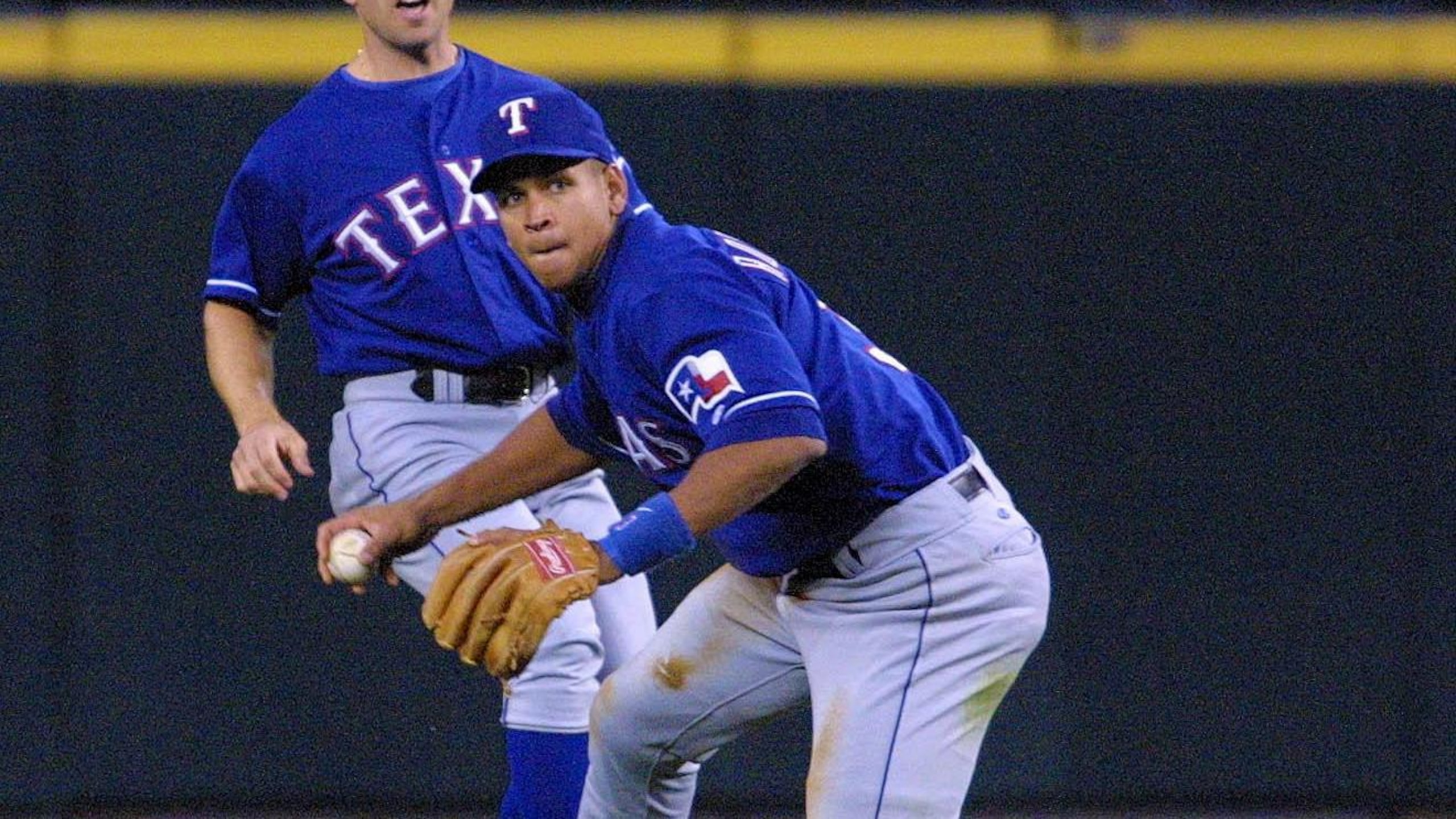 Texas Rangers Alex Rodriguez (R) scrambles to get Texas Rangers Alex Rodriguez (R) scrambles to get