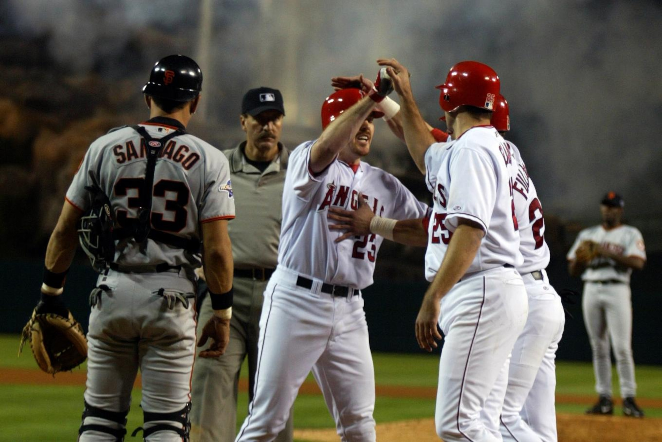 054963.SP.1026.angels.AJS Anaheim Angels Scott Spiezio is greeted at homeplate after hitting a thr