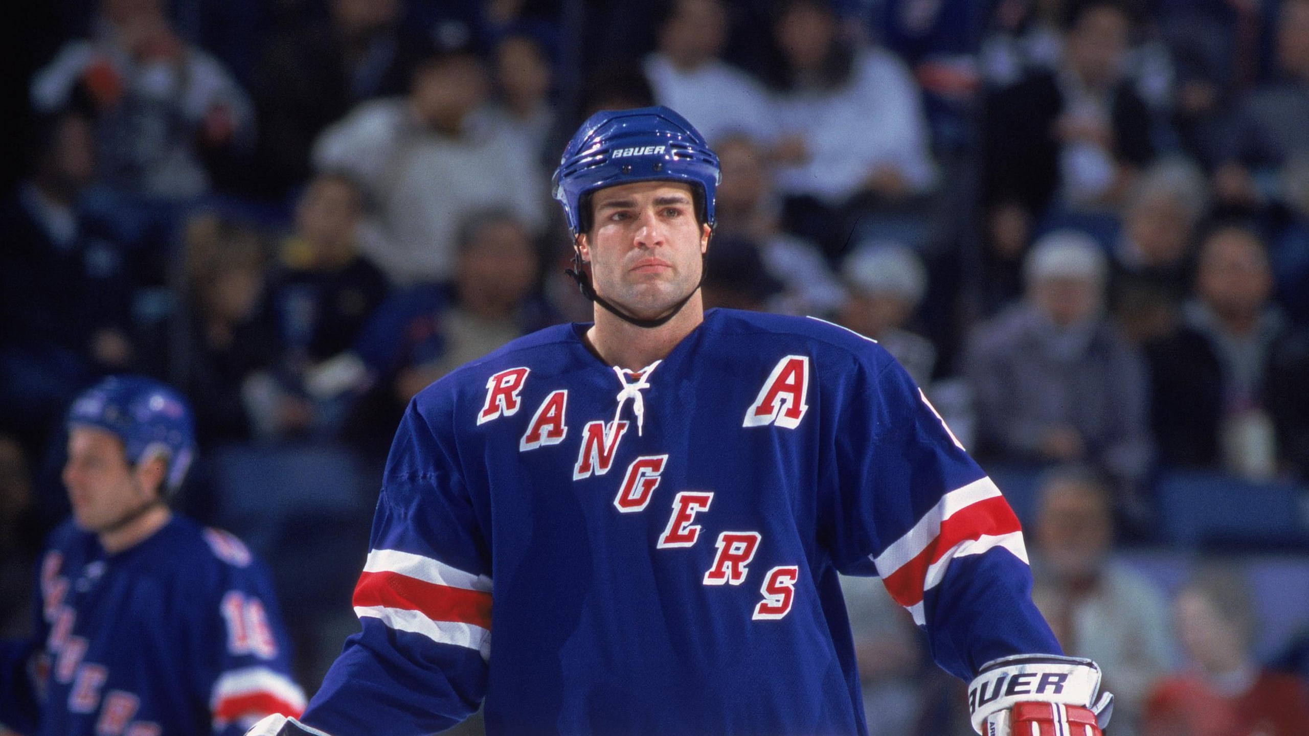 Eric Lindros looks on