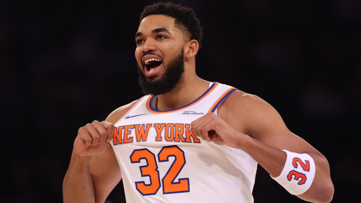 Jalen Brunson and Karl-Anthony Towns celebrating on the court after winning the NBA championship