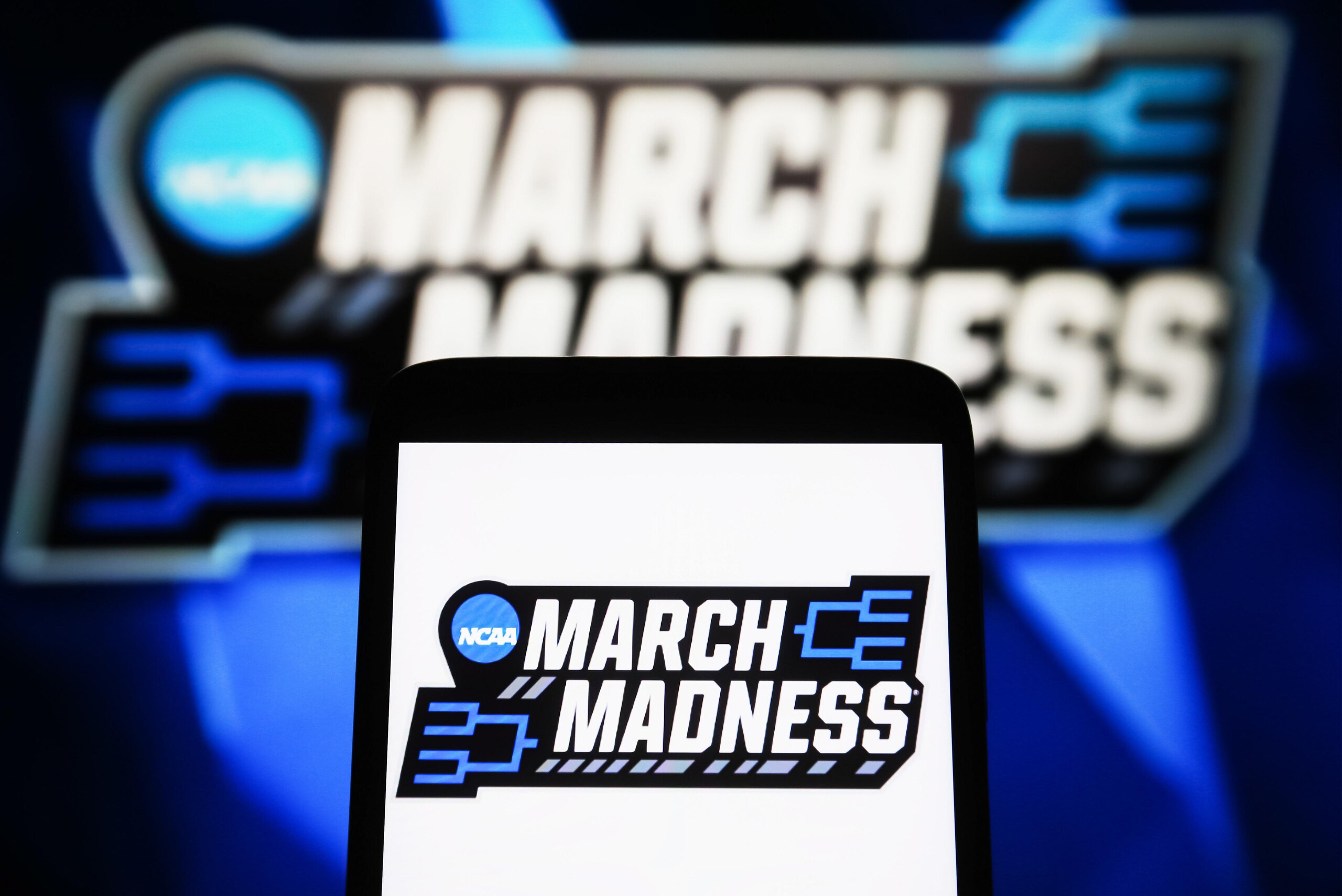 In this photo illustration, a March Madness (NCAA Division I... In this photo illustration, a March Madness (NCAA Division I...