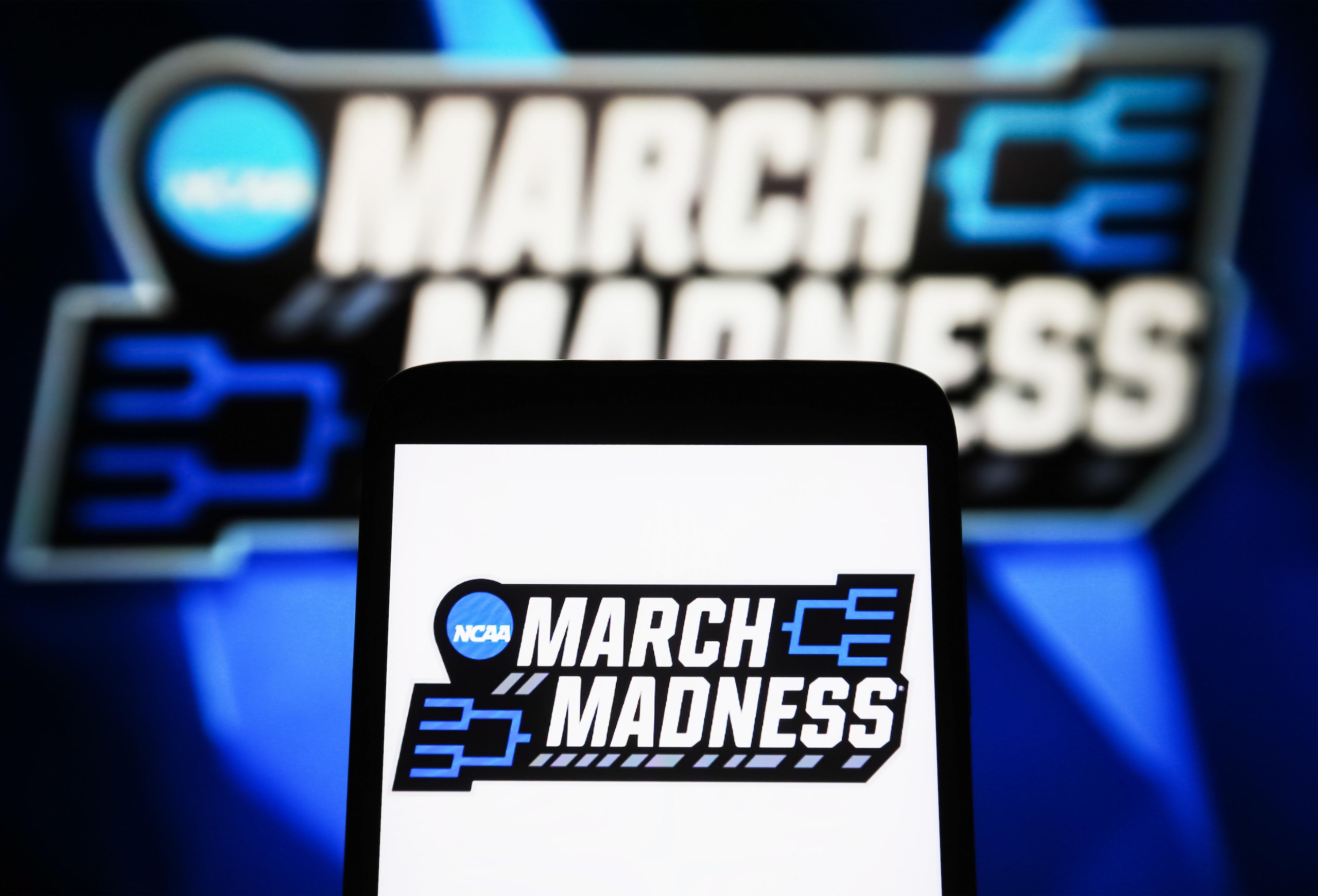 In this photo illustration, a March Madness (NCAA Division I... In this photo illustration, a March Madness (NCAA Division I...