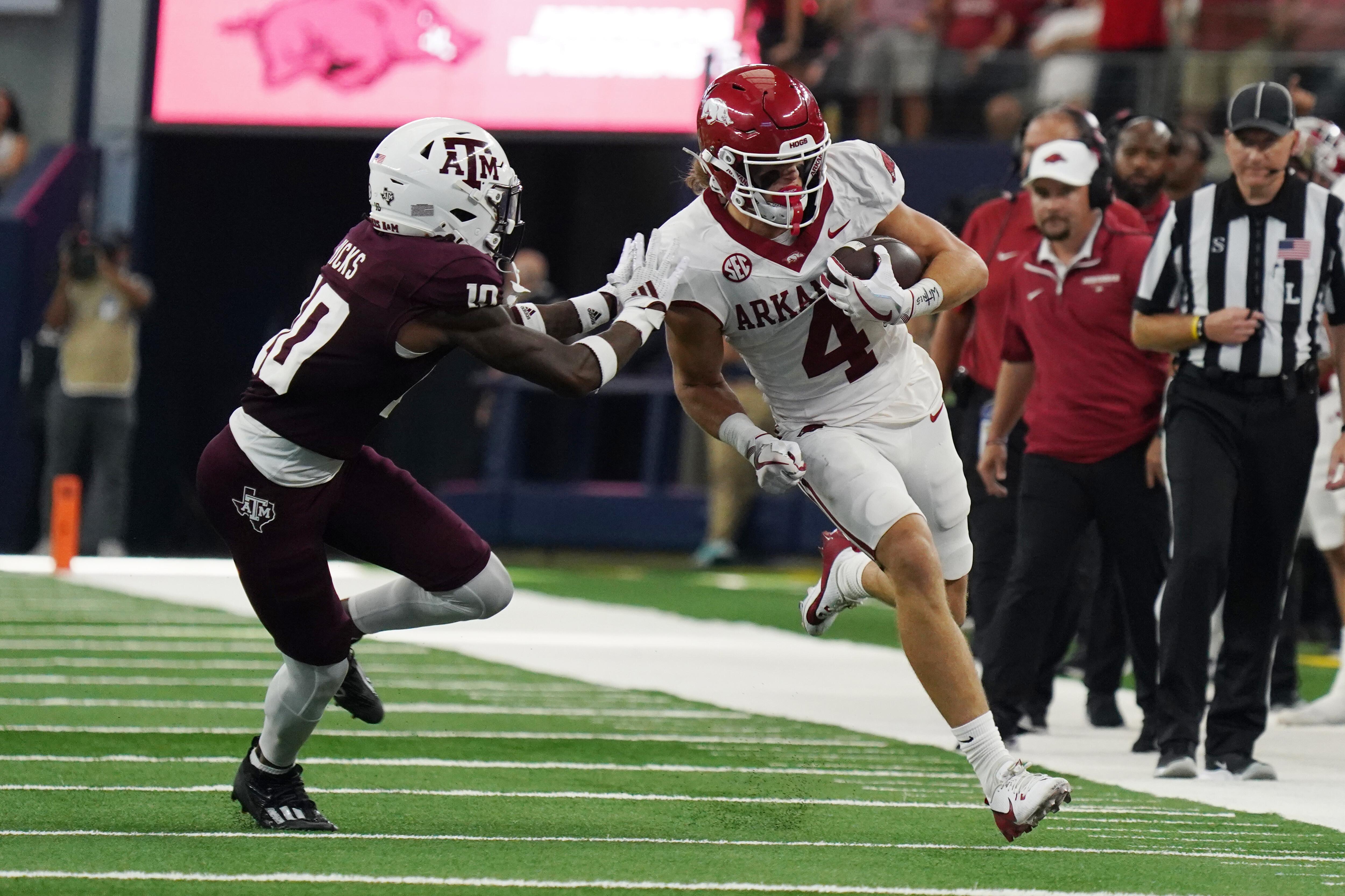 Arkansas Razorbacks wide receiver Isaac TeSlaa #4 rushes...