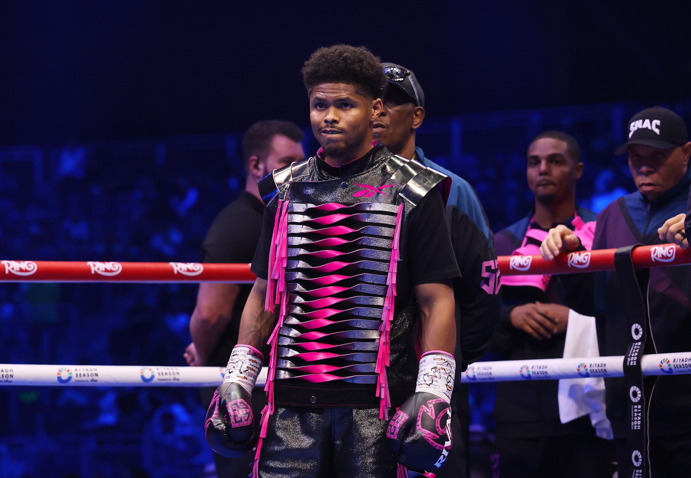 Shakur Stevenson enters the ring wearing black-and-pink boxing equipment in an earlier lightweight appearance