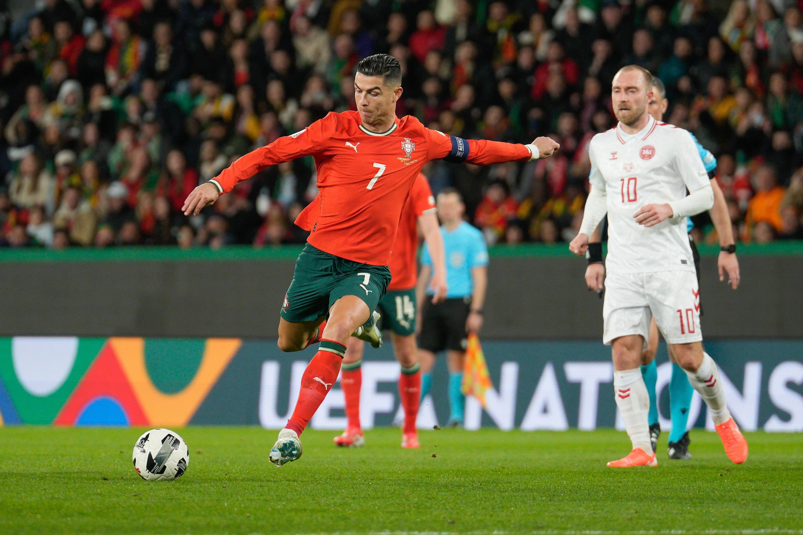 Cristiano Ronaldo of Portugal (L) and Christian Eriksen of...