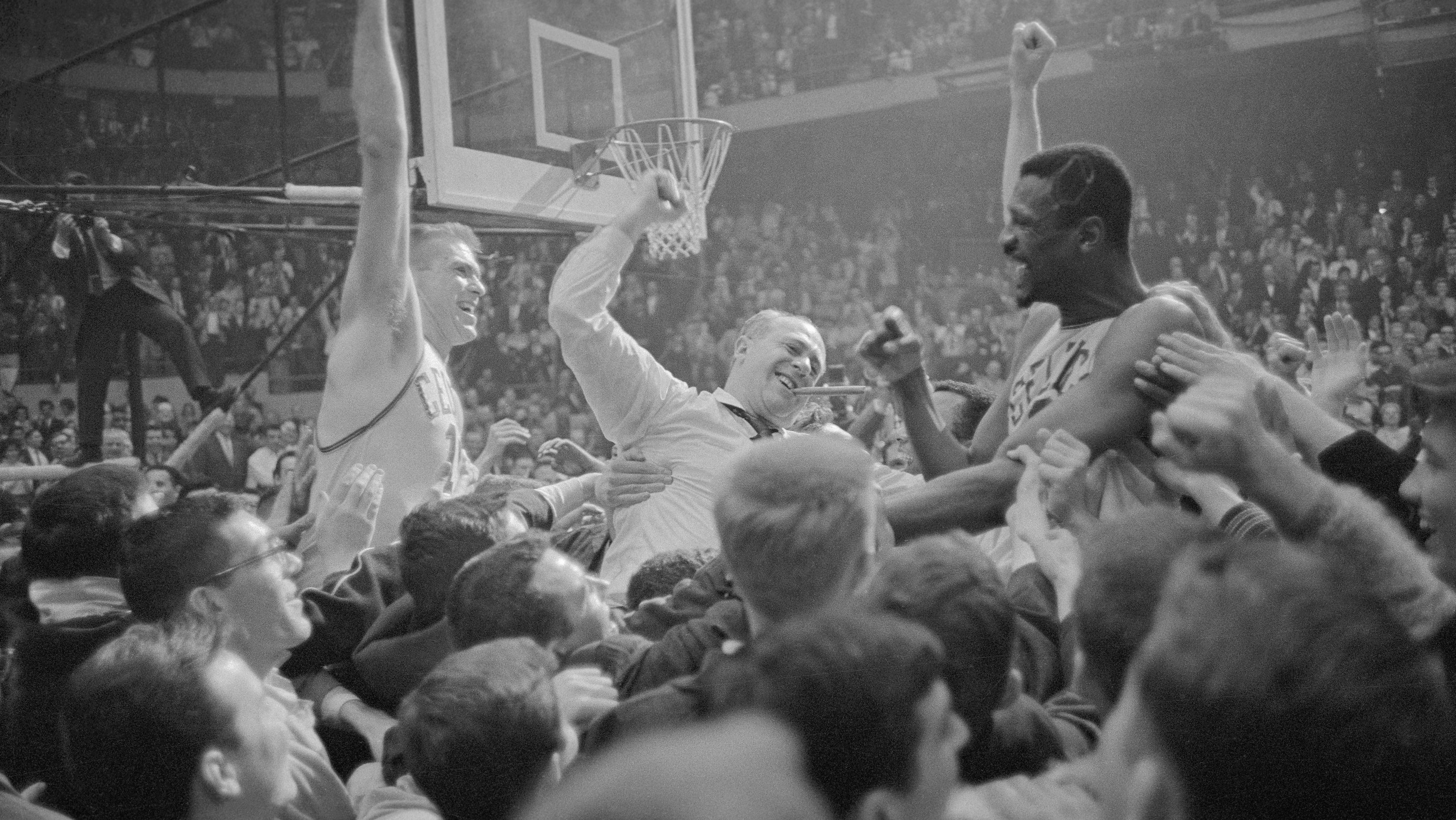 Celtics Coach and Players Being Carried by Jubilant Fans