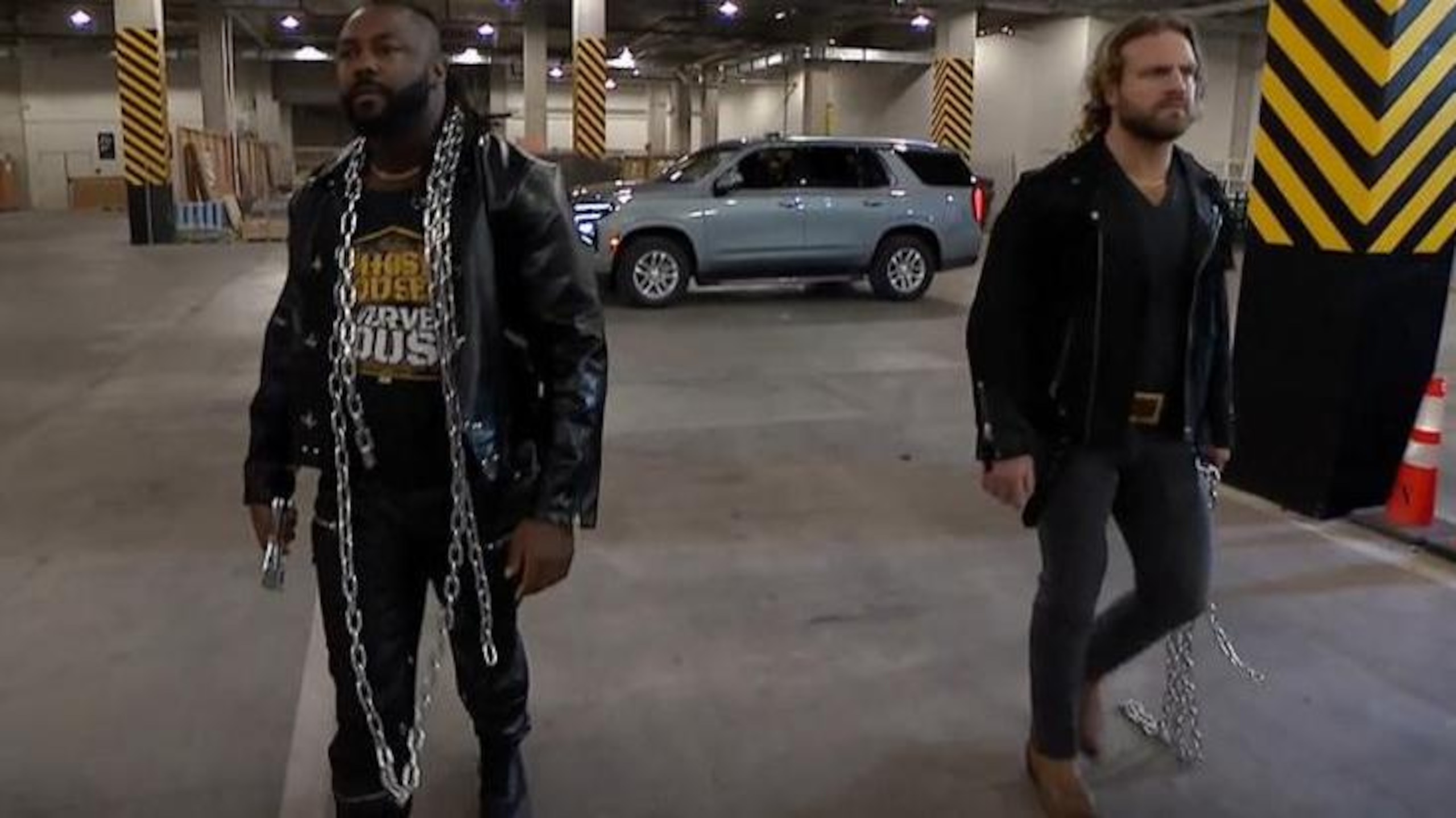 Hangman Adam Page and Swerve Strickland stand together.